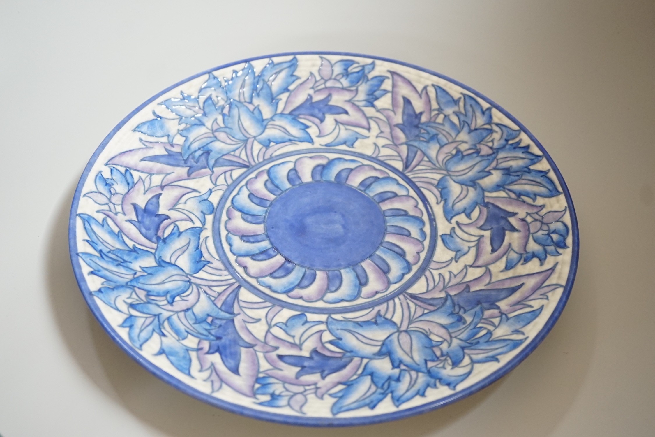 A Burleigh ware Charlotte Rhead lustre jug and a Crown Ducal dish, diameter 32cm